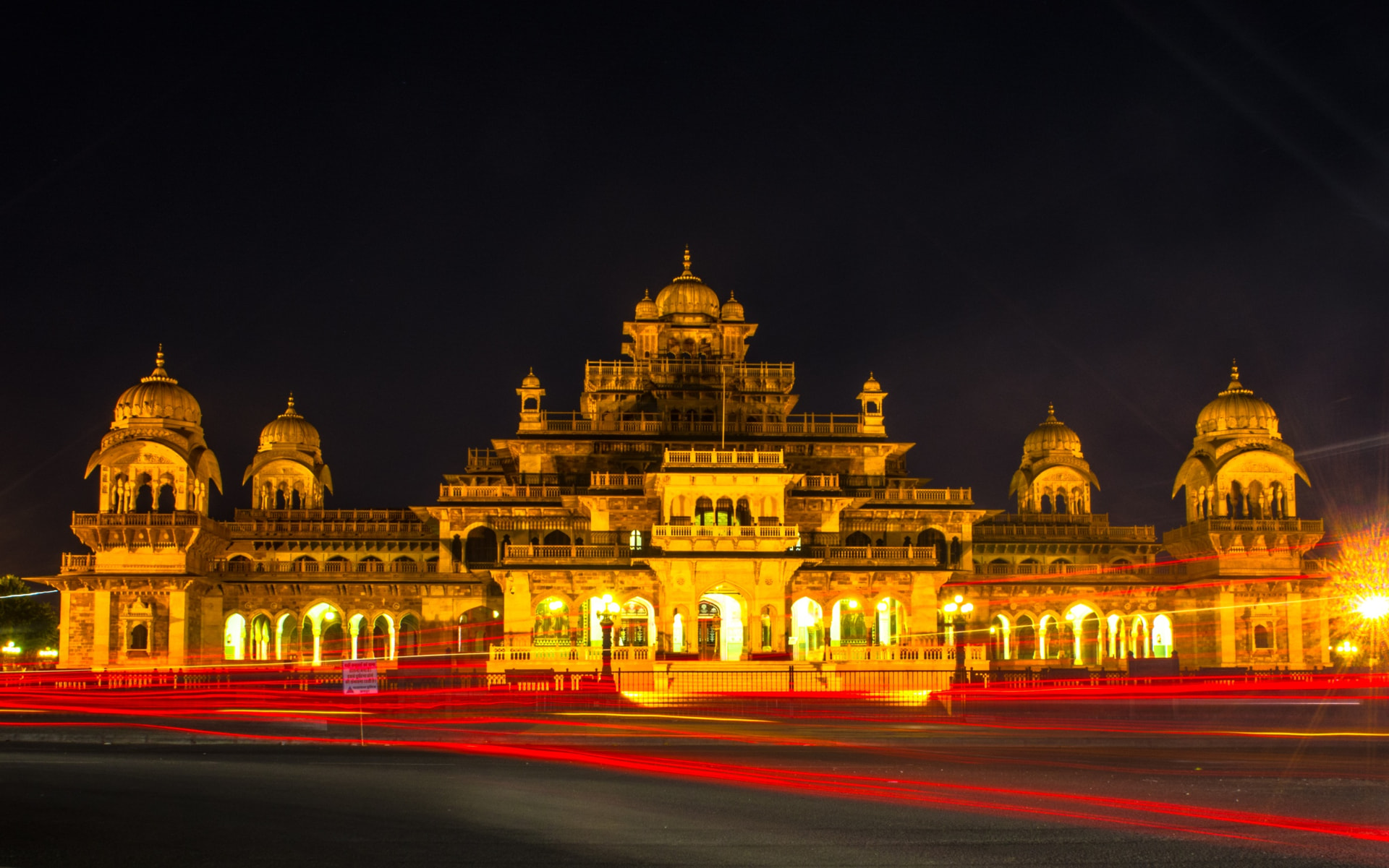 Albert Hall Museum in Jaipur illuminated at night with light trails from passing traffic